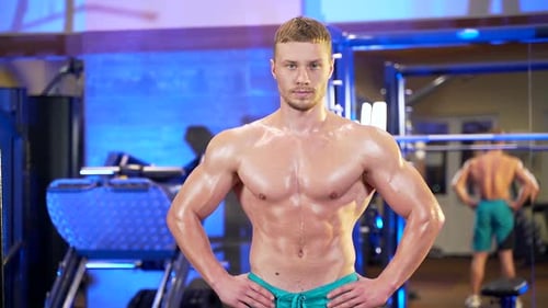 Sweaty Muscular Man Posing in Gym