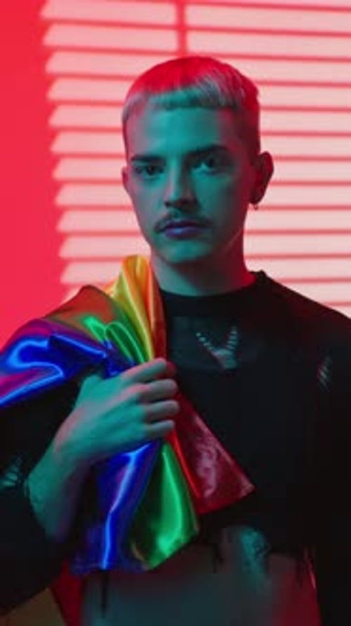 Young Adult Posing with Pride Flag
