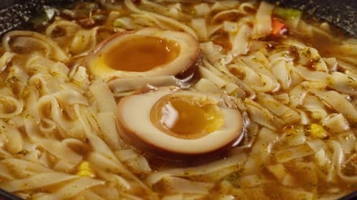 Close-Up of Savory Noodle Soup with Egg