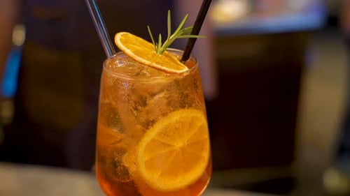 Orange cocktail at a bar. Beautifully decorated delicious alcoholic drink.