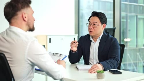 Businessmen Having a Business Meeting in a Modern Office Discussing Charts