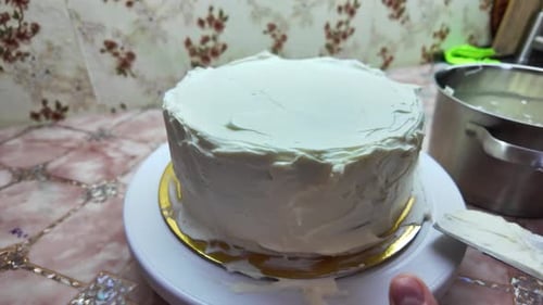 Hand Icing Cake with White Frosting