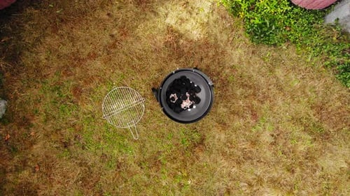 Top View Of Round Barbecue Grill With Lit Charcoal Prepared Outdoor For Cooking. overhead