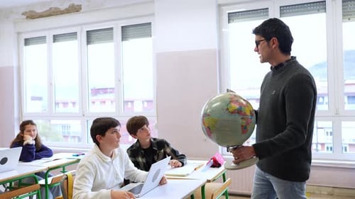 Teacher Explains Geography to Attentive Students in Classroom