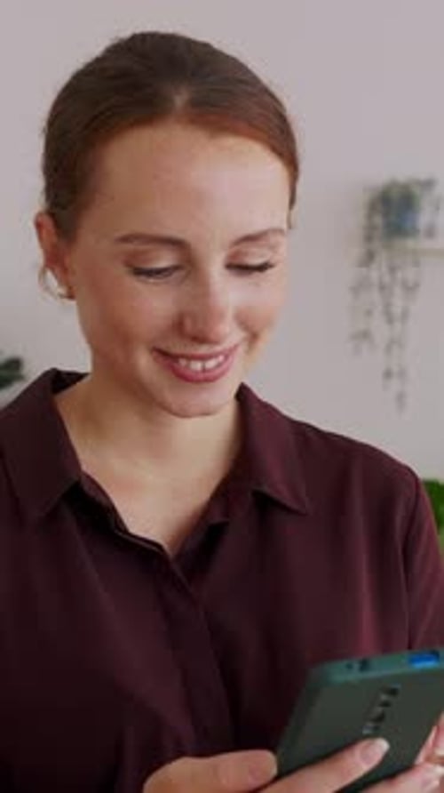 Young Happy Professional Businesswoman Using Mobile Phone at Home Office