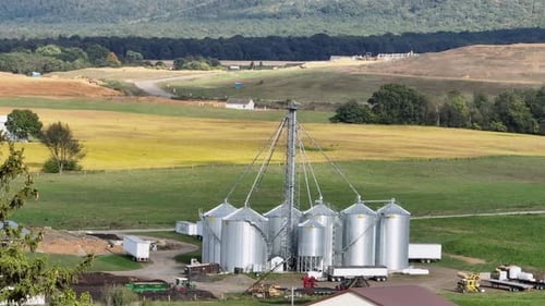 Scenic Aerial View of Modern Grain Silos in Rural Farmland