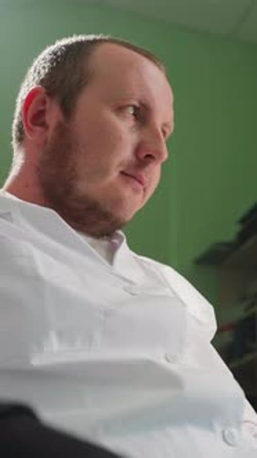 Adult in White Coat Looking