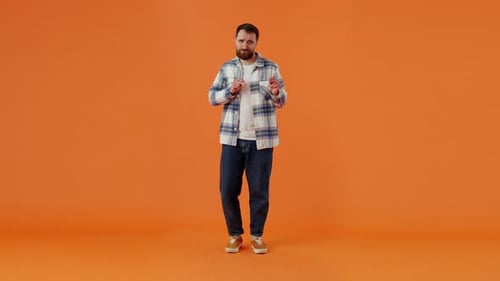 Portrait of Extremely Positive Man Being in Good Festive Mood Dancing Raising Hands