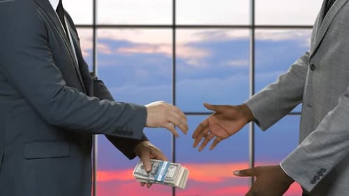 Handshake of Men with Dollars