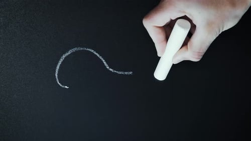 Hand Writes Swirling Chalk Line on Blackboard
