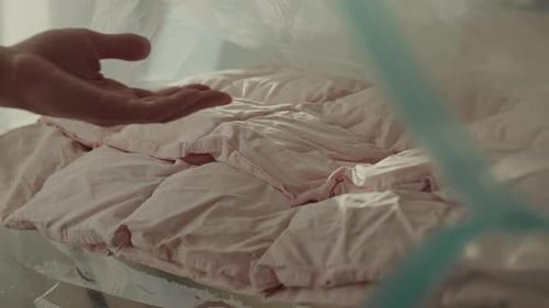 Pink Comforter Inside of Plastic Zippered Bag