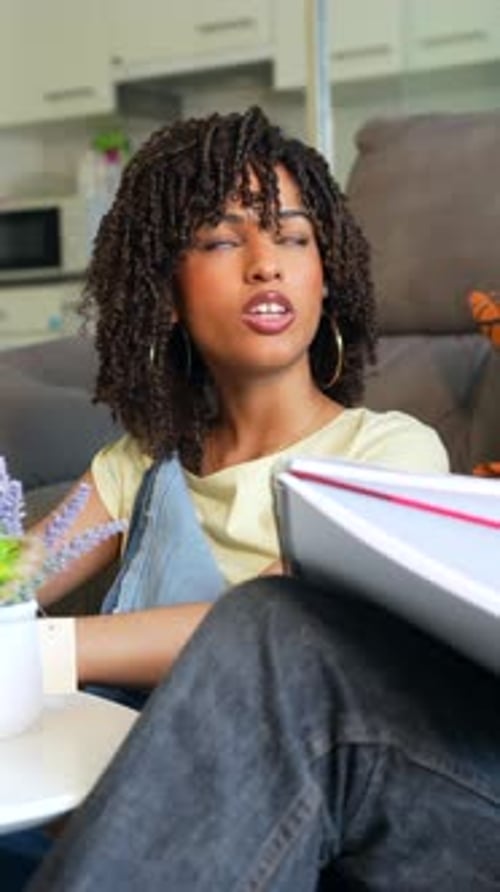 Young Adults Talk with Notebook Indoors