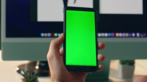 Hand Holds Green Screen Phone and Taps