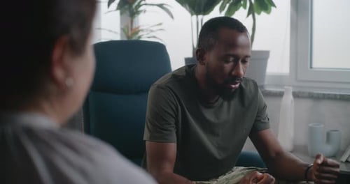 Man Talking to Therapist in Bright Consulting Room