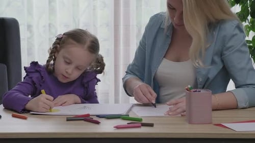 Child and Woman Drawing Together at Table
