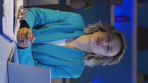 Vertical video of Home office worker woman looking annoyed at camera.