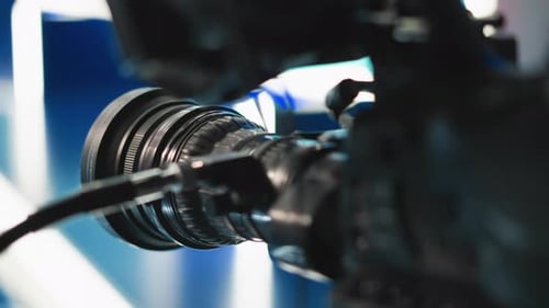 Close Up Camera Lens Focus Ring with Cables Reflecting Blue Studio Lights
