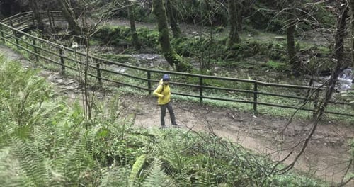 Young woman walking in forest during trekking day in to the woods - Travel, nature and winter sport