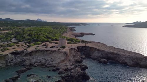 mediterranean coastal sunset ancient historic tower. Amazing aerial top view flight wide orbit overv