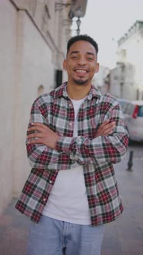 Vertical Portrait of a Young African American Man on the Street A Young Guy Stands on the Street and
