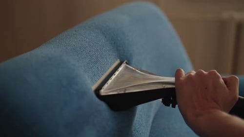 Close Up Couch Cleaning With a Technology Device