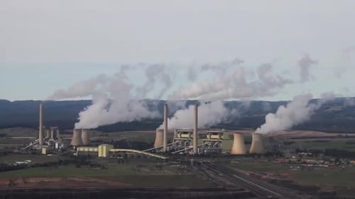 Aerial perspective of Hazelwood Power Station with billowing plumes being pumped into the atmosphere