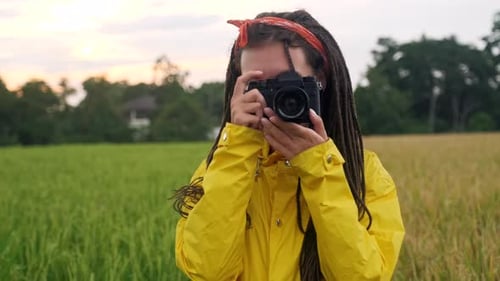 Smiling Woman Taking Pictures in Beautiful Rural Field