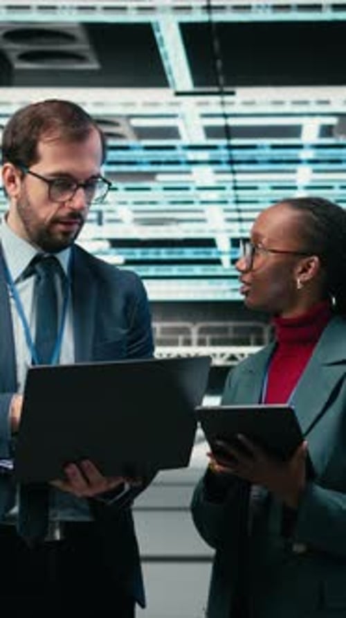 Vertical Video Portrait of Smiling Data Center Engineering Team Using Laptop and AR Simulation