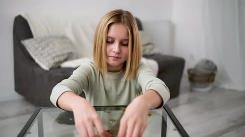 Cute Little Girl Sorting And Counting Loose Change