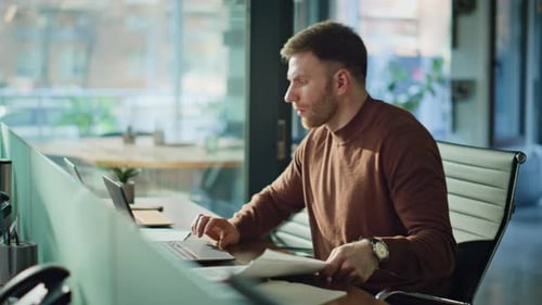 Man Celebrating Business Success in Modern Office