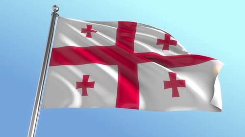 Waving Flag of Georgia Against Clear Blue Sky