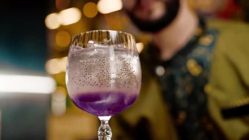 professional bartender creates a cocktail drink pours alcohol into a measuring glass at the bar