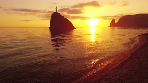 Aerial View on Sunset Over Calm Sea and Volcanic Rocky Shores