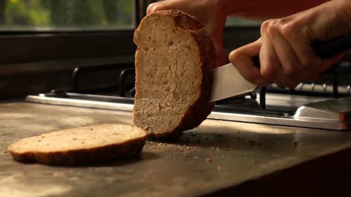 Woman Slicing Whole Grain Bread Slow Motion