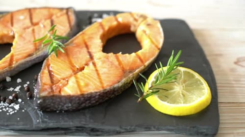 Delicious grilled salmon steak with lemon and rosemary