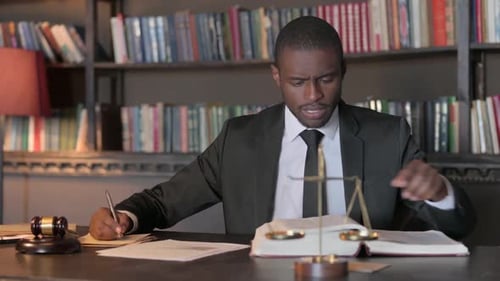 African American Lawyer Working on Documents in Office