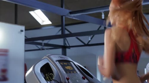 Woman Increases the Speed of Treadmill at the Fitness Centre