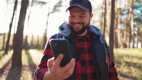 Active Man Hiking in Forest Alone Tourist with Carrying Backpack Hiking Finding Route Way Looking at