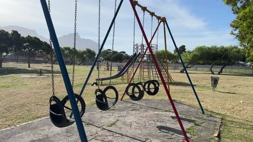 An empty kids play park with no kids on the swings at a park in the southern suburbs of Cape Town in
