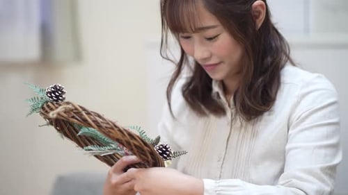 Woman Crafts Holiday Wreath in Her Home