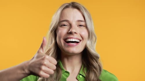 Smiling Woman Gives a Thumbs Up Gesture