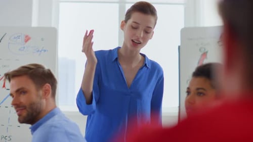 Woman Giving Presentation at Office Meeting