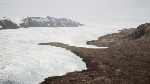 Aerial View of Expansive Glacier and Mountain Landscape