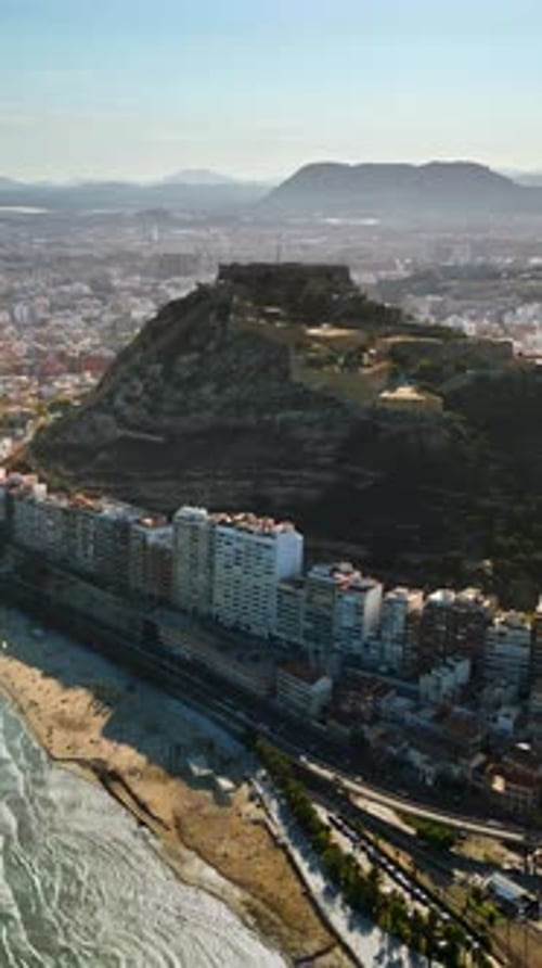 Aerial drone view of the Santa Barbara Castle on the coast of Alicante, Spain with the city and the