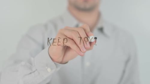 Man Writes "Keep Trying" with Marker