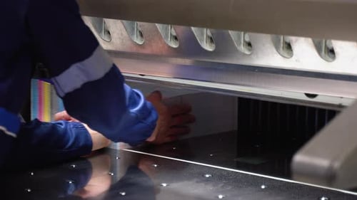 Worker Cutting Paper Using Paper Cutting Machine in a Printing Factory Printing Cutting Machine
