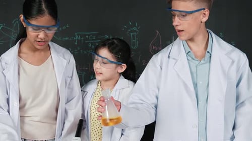 Students Doing Science Experiment in Classroom with Microscope