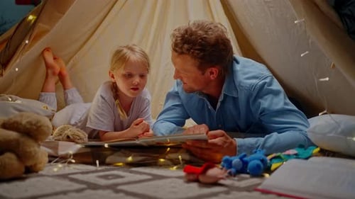 Father and Daughter Reading in Blanket Fort