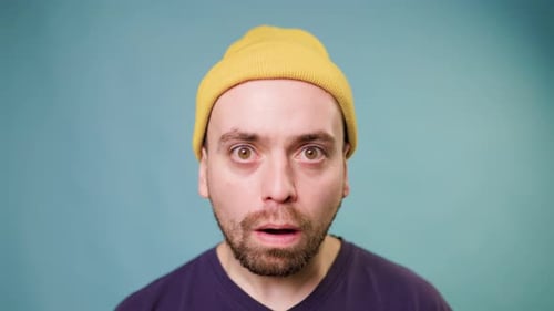 Man with Yellow Beanie Looks Surprised