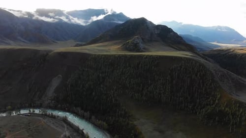 Breathtaking Mountain Valley Reveals a Meandering River Flowing Through Vibrant Green Forests Bright